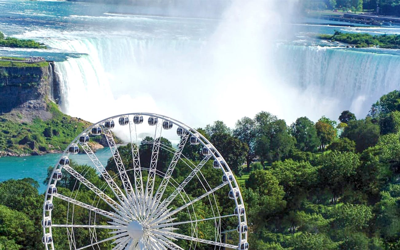 Niagara SkyWheel view of Niagara Falls with lush greenery and cascading water.