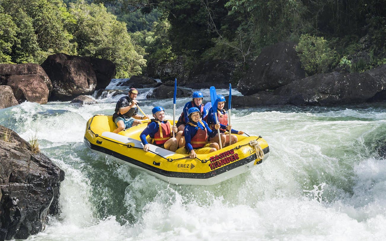 Rafting group navigating rapids on Barron River during Guided Raging Thunder Rafting Experience.