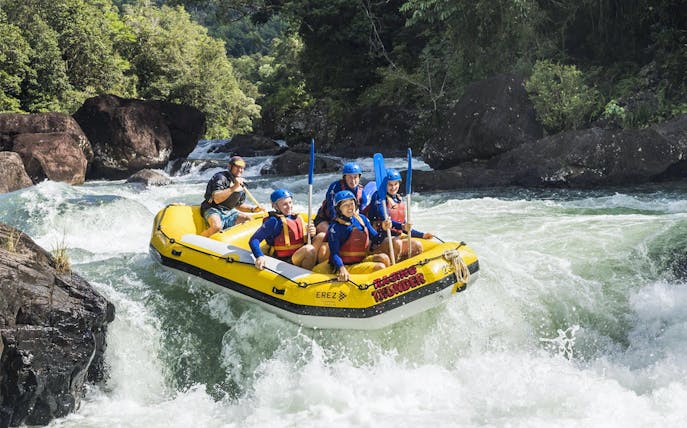 Rafting group navigating rapids on Barron River during Guided Raging Thunder Rafting Experience.