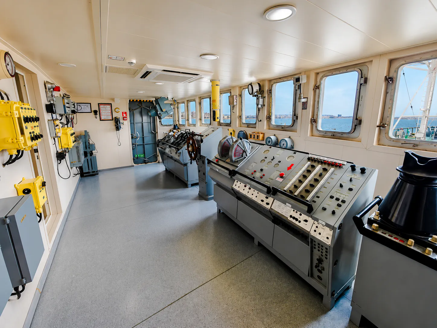 Control room of the world's first tanker museum in Baku, featuring navigation equipment and sea view.