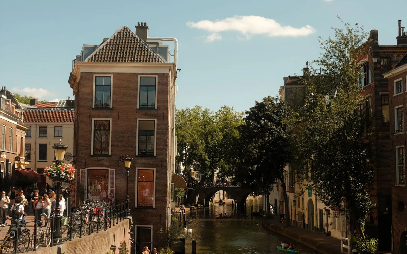 Canal view in Utrecht with historic buildings and a bridge, part of the Hidden Stories Walking Tour.