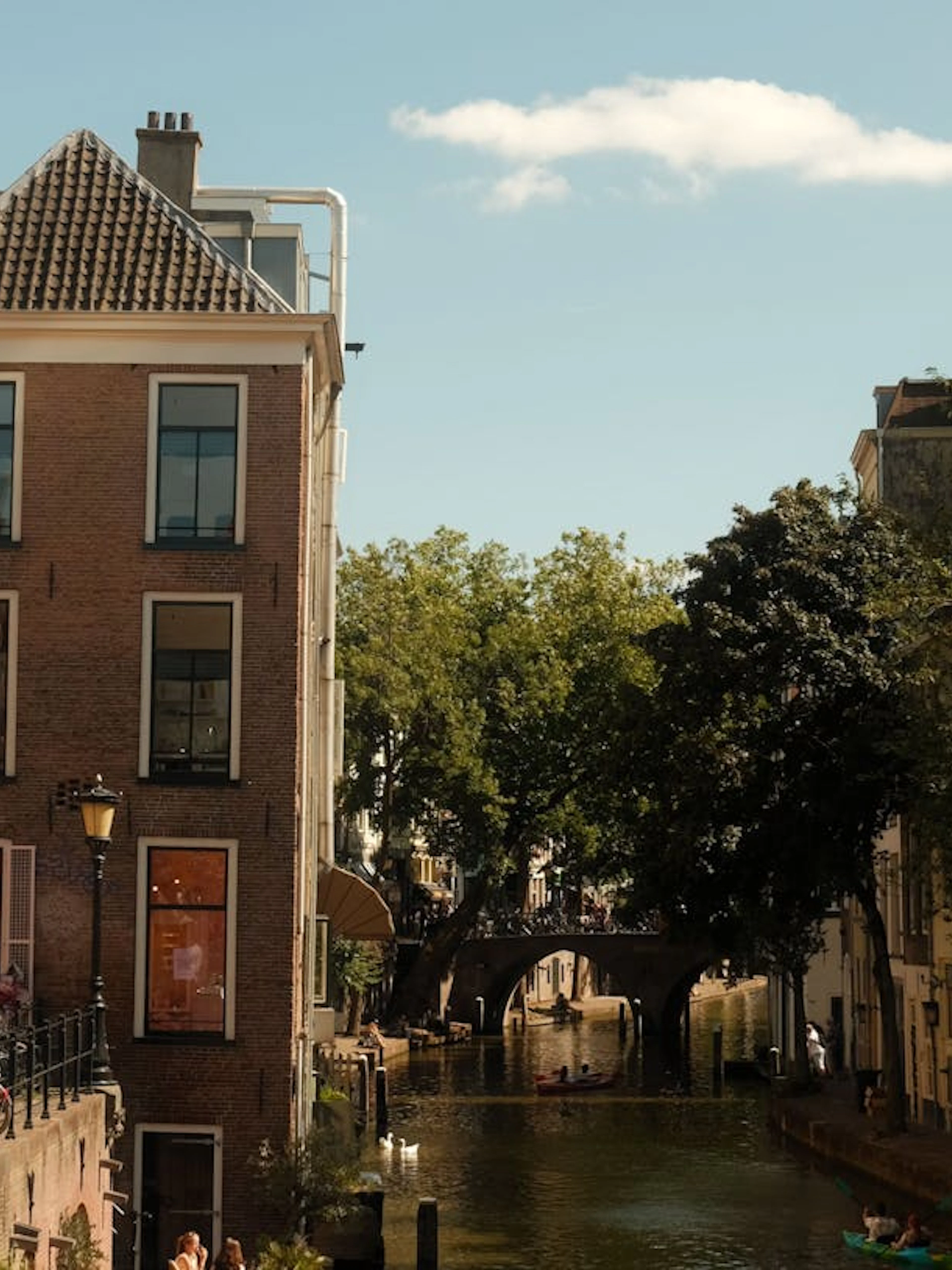 Canal view in Utrecht with historic buildings and a bridge, part of the Hidden Stories Walking Tour.