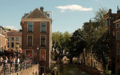 Canal view in Utrecht with historic buildings and a bridge, part of the Hidden Stories Walking Tour.