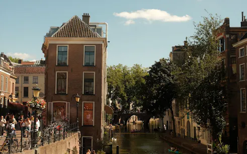Canal view in Utrecht with historic buildings and a bridge, part of the Hidden Stories Walking Tour.