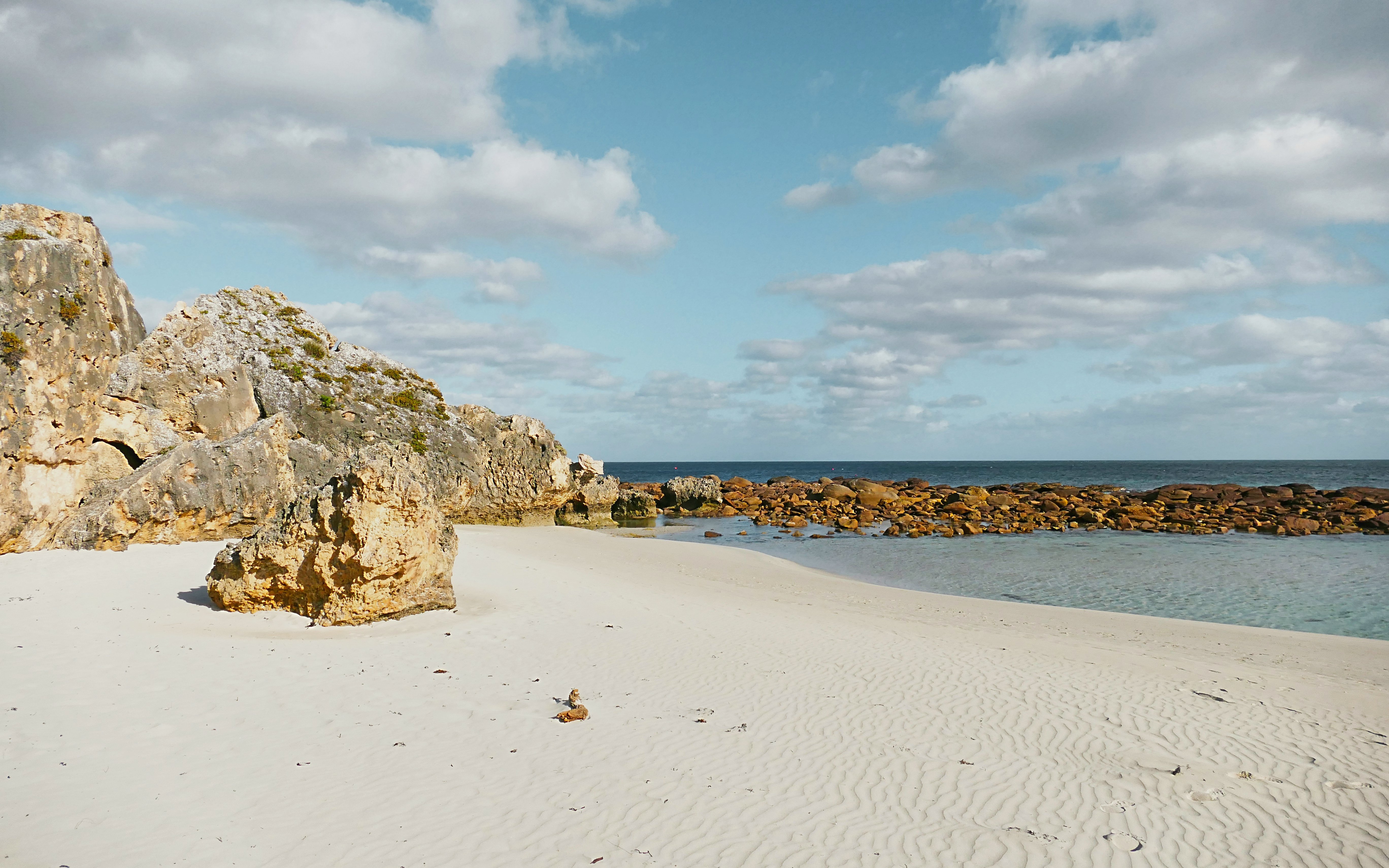 Coastal rocks and sandy beach at Stokes Bay, Kangaroo Island.