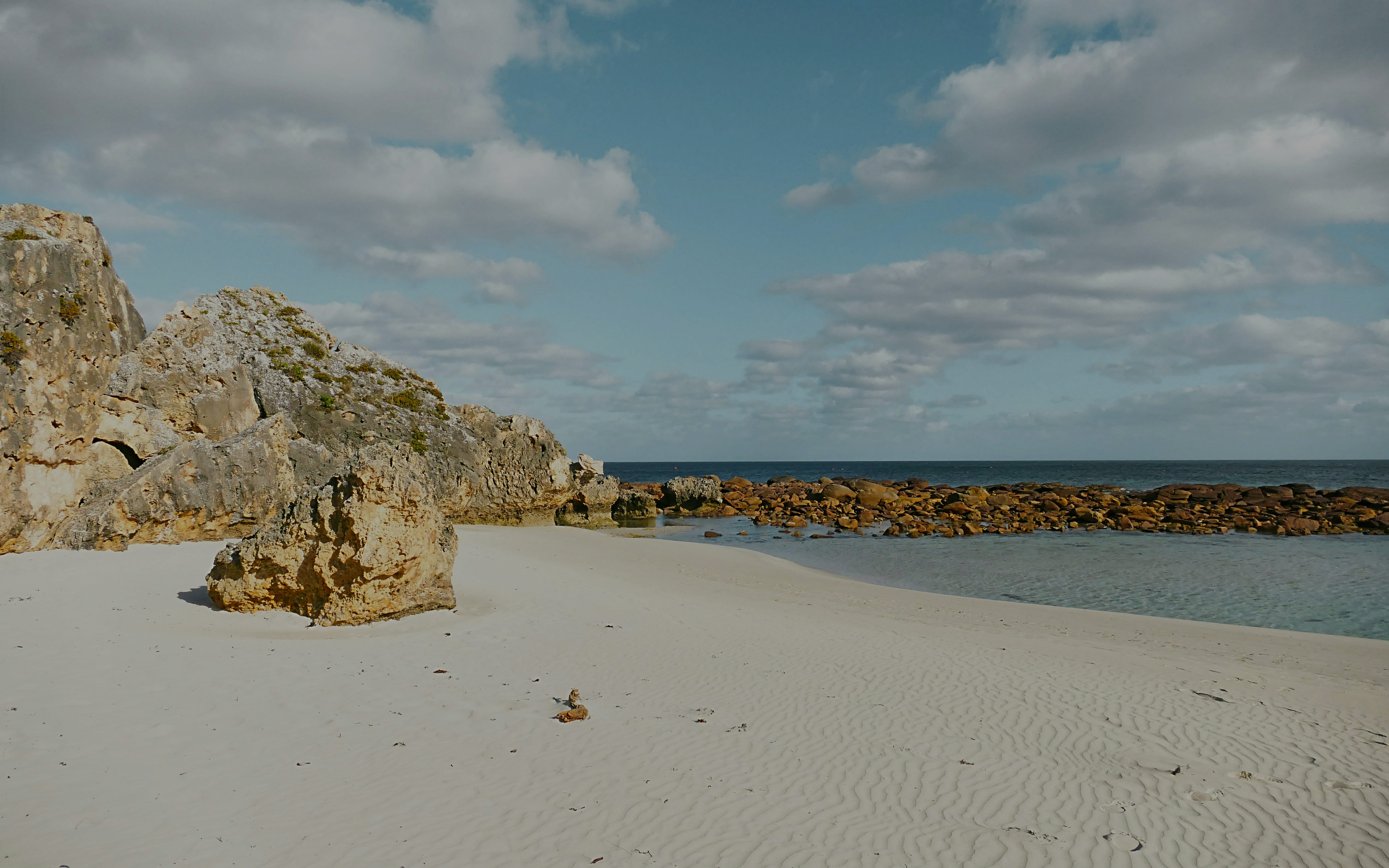 Coastal rocks and sandy beach at Stokes Bay, Kangaroo Island.