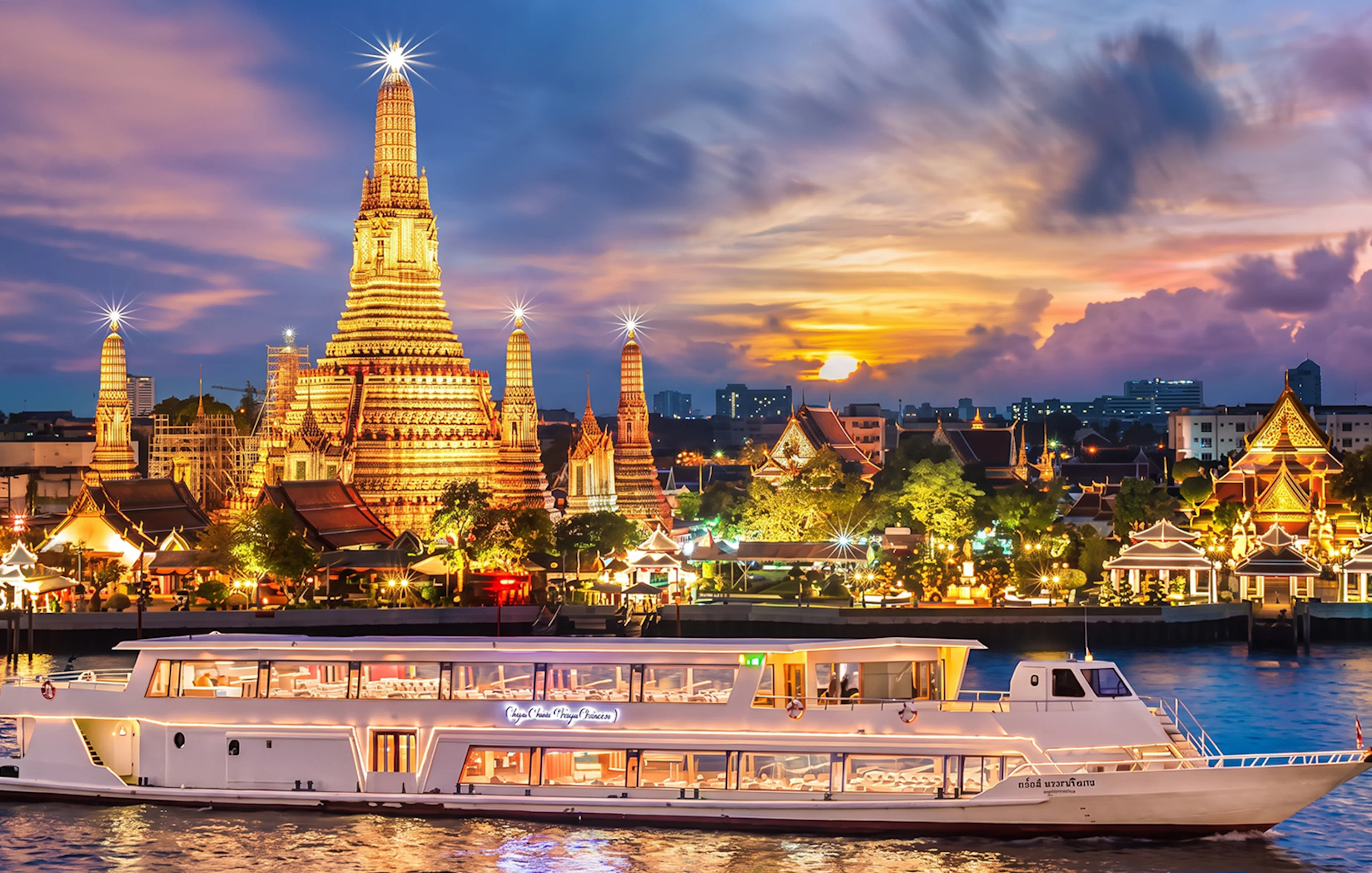Chao Phraya Princess cruise passing Wat Arun at sunset during New Year's Eve in Bangkok.