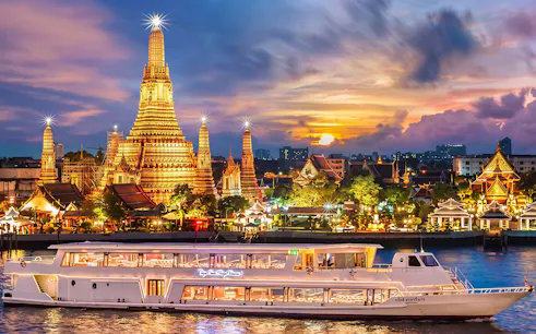 Chao Phraya Princess cruise passing Wat Arun at sunset during New Year's Eve in Bangkok.