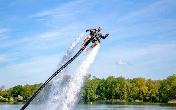 Person using a jetpack over water at The Palm Jumeirah.