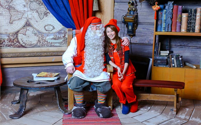 Meeting Santa Claus in Santa’s Village with a festive backdrop.