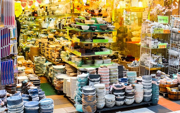Ceramic dishware display in Osaka market during guided food tour.