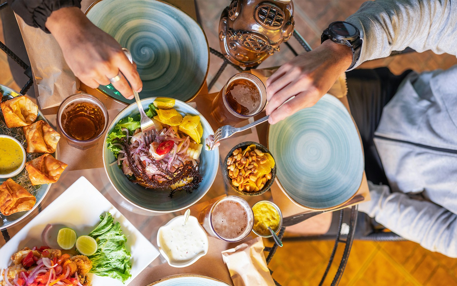 Peruvian ceviche with plantains and peanuts on a table setting.