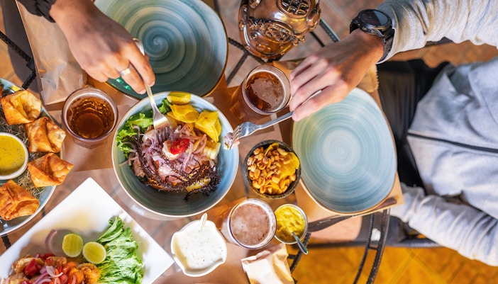 Peruvian ceviche with plantains and peanuts on a table setting.
