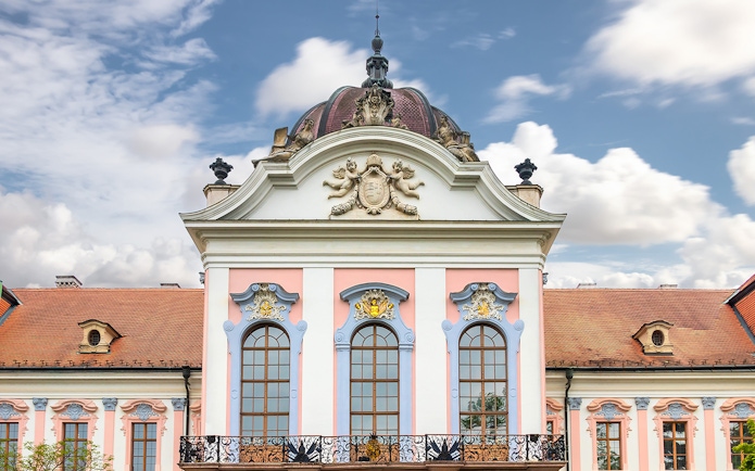 Gödöllő Royal Palace facade with ornate windows and decorative elements, Hungary.