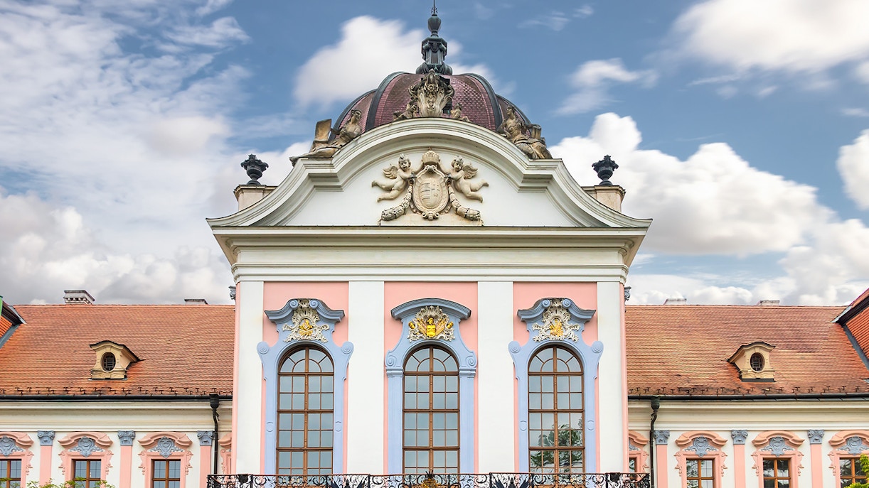 Gödöllő Royal Palace facade with ornate windows and decorative elements, Hungary.