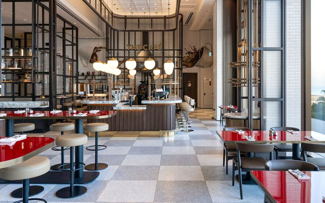 Dining area at Gastronomy, Dubai with modern decor and red tables.