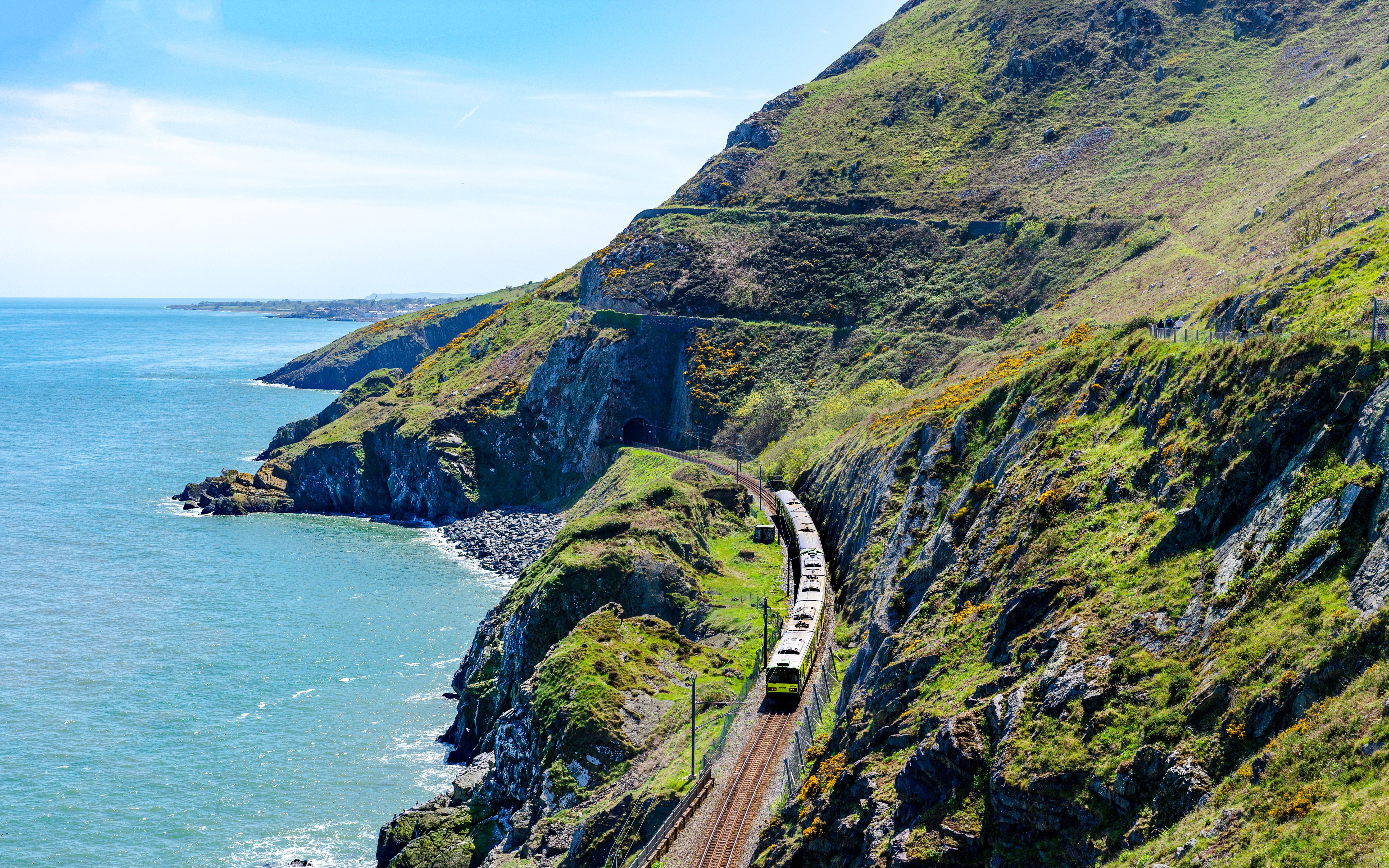 Train traveling along the scenic coastal cliffs of Ireland.