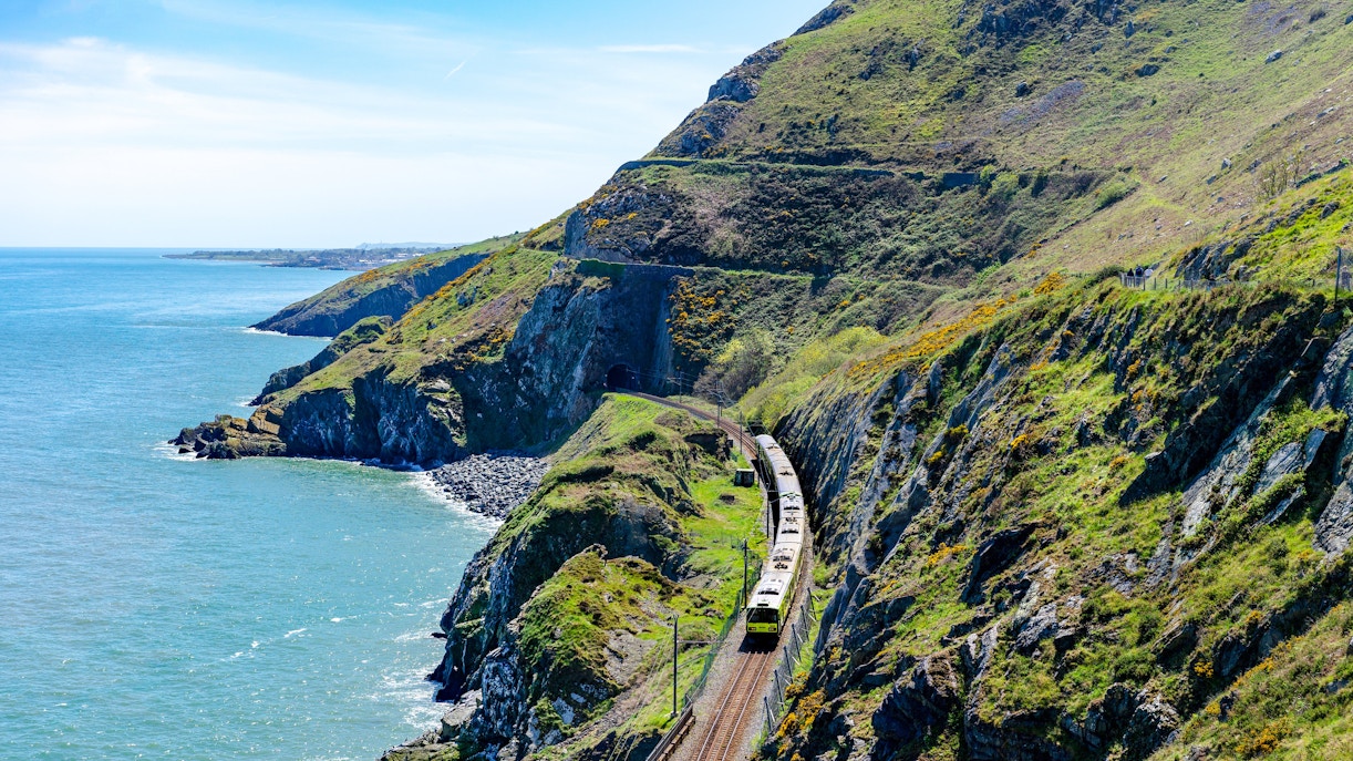 Train traveling along the scenic coastal cliffs of Ireland.