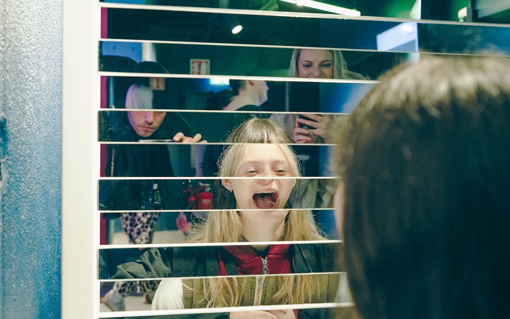 Guests interacting with mirror exhibit at World of Illusion, Dublin.
