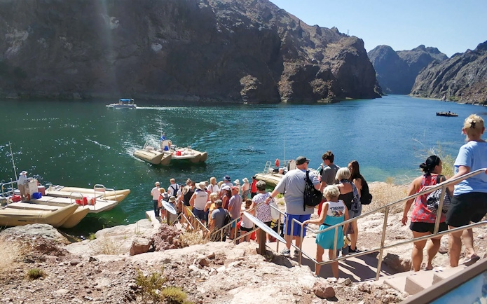 Guests lining up to board rafts for Hoover Dam sightseeing tour.