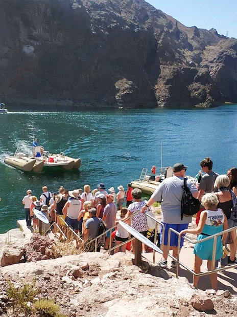 Guests lining up to board rafts for Hoover Dam sightseeing tour.