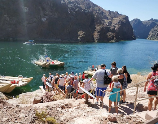 Guests lining up to board rafts for Hoover Dam sightseeing tour.
