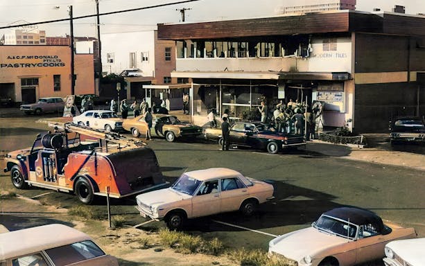 Crowd gathers outside a building in Fortitude Valley during a true crime tour.
