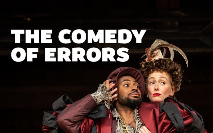 Actors in period costumes performing "The Comedy of Errors" on stage.