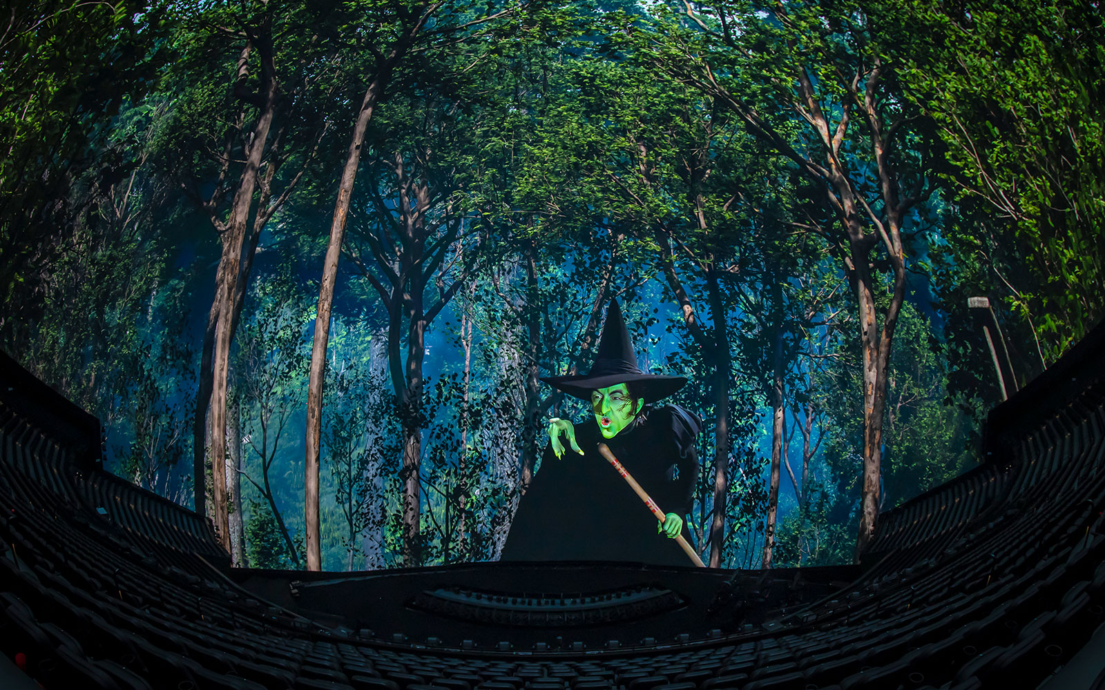 Wicked Witch scene from Wizard of Oz show at Sphere, surrounded by forest backdrop.