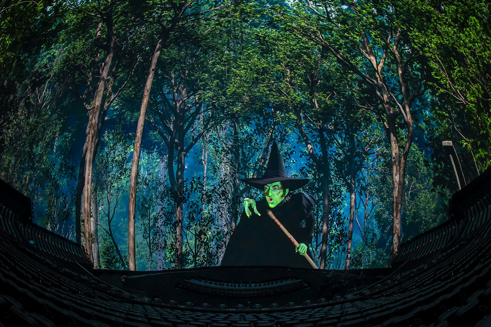 Wicked Witch scene from Wizard of Oz show at Sphere, surrounded by forest backdrop.