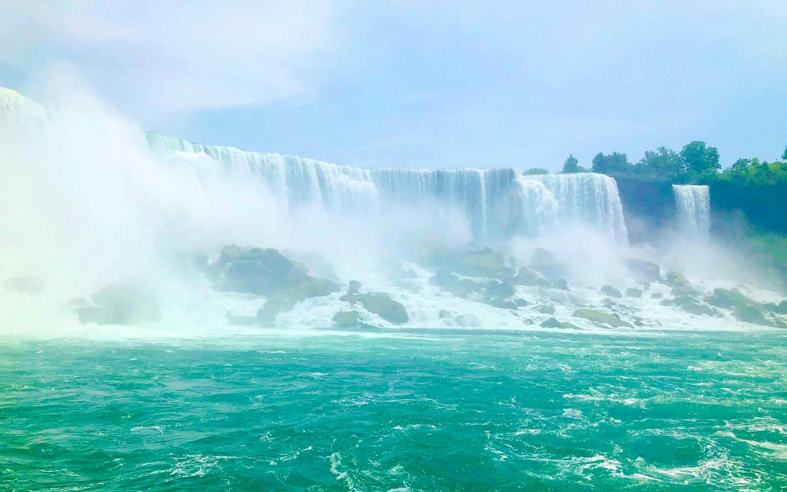 Niagara Falls USA with cascading water and mist over rocks.