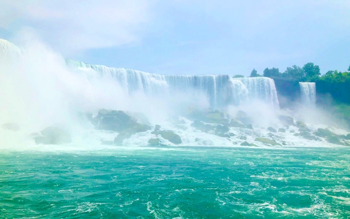 Niagara Falls USA with cascading water and mist over rocks.
