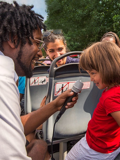 Tour guide interacting with a child on a Los Angeles hop-on hop-off bus tour.