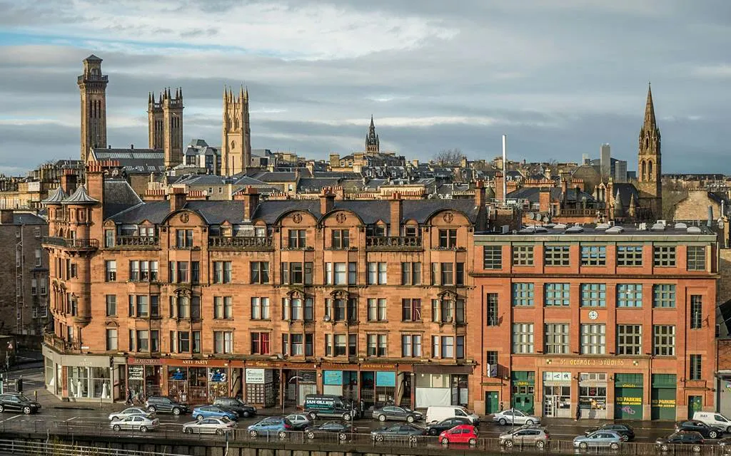 Historic buildings and skyline in Glasgow's West End, part of a self-guided city exploration game.
