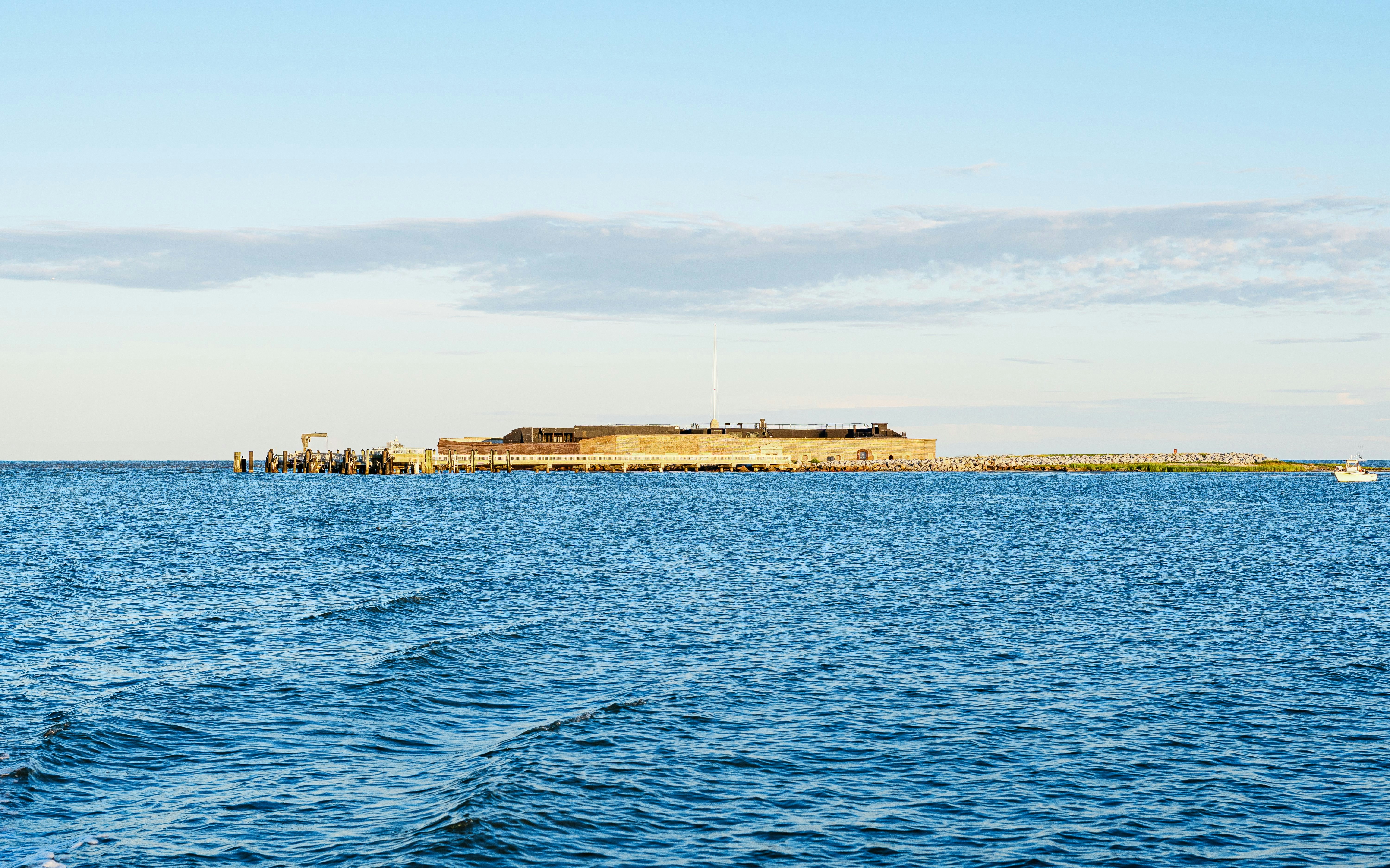 Fort Sumter National Monument viewed from the water at sunset.
