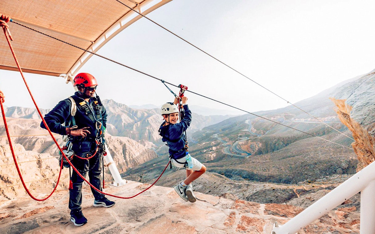 Child on harness at Jais Sky Tour platform, Jebel Jais mountains.