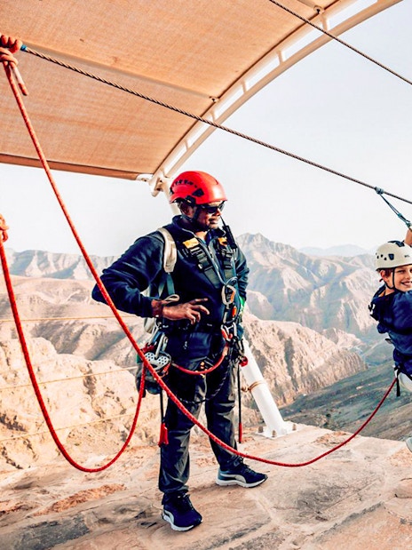 Child on harness at Jais Sky Tour platform, Jebel Jais mountains.