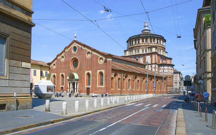 Santa Maria delle Grazie church in Milan, Italy, with tram tracks in foreground.