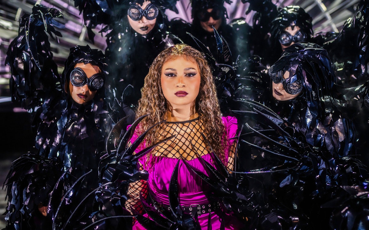 Performers in elaborate costumes on stage at Friedrichstadt Palast.