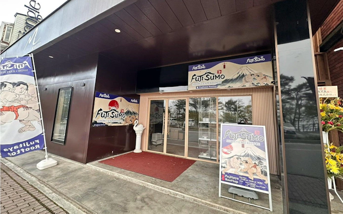 Entrance to Fuji Sumo Show and Experience in Yamanashi, featuring promotional banners.