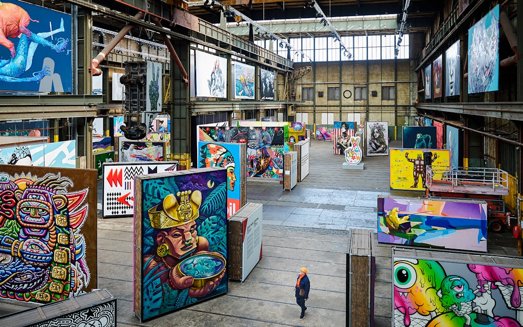 Straat Museum exhibits featuring vibrant street art in an industrial gallery setting.
