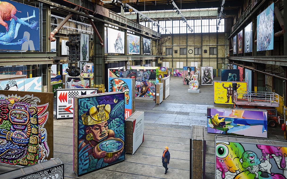 Straat Museum exhibits featuring vibrant street art in an industrial gallery setting.