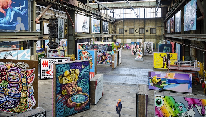 Straat Museum exhibits featuring vibrant street art in an industrial gallery setting.