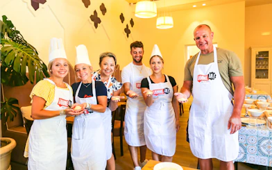 Tourists holding ravioli at Neapolitan Cooking School in Sorrento.