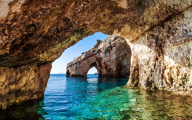 Keri caves with turquoise waters on Marathonisi Island, Greece.