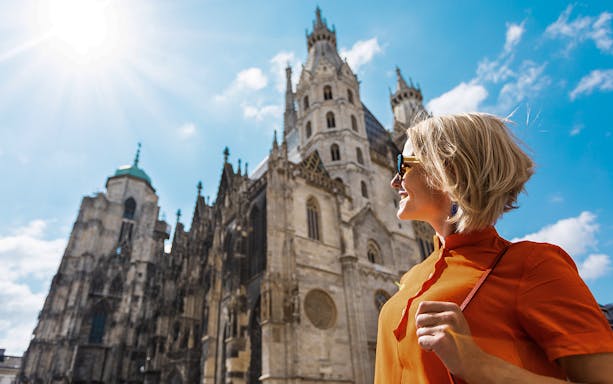 Young woman in orange dress near St. Stephen's Cathedral, Vienna.