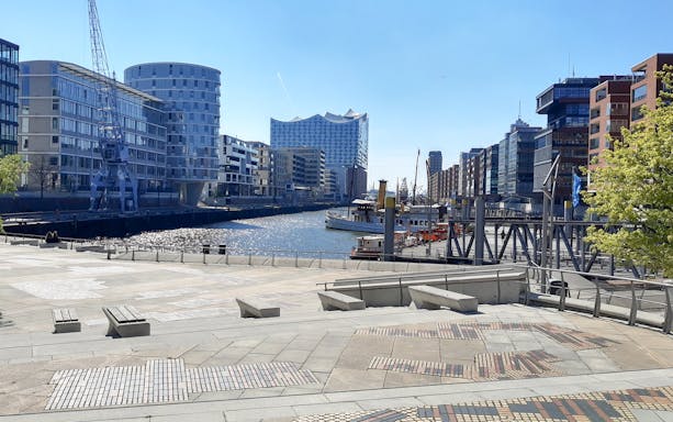 Elbphilharmonie exterior view with harbor and modern buildings in Hamburg.