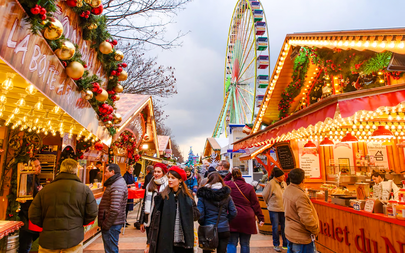 Paris Christmas Market with festive stalls and a Ferris wheel in the background.
