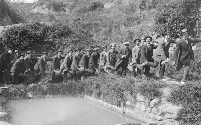 Group of men posing playfully by a pond at KBr Fundación MAPFRE Barcelona Photo Center.