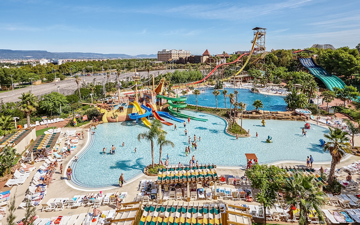 Tallest free fall water slide at Costa Caribe Port Aventura, Spain, with pools and visitors.